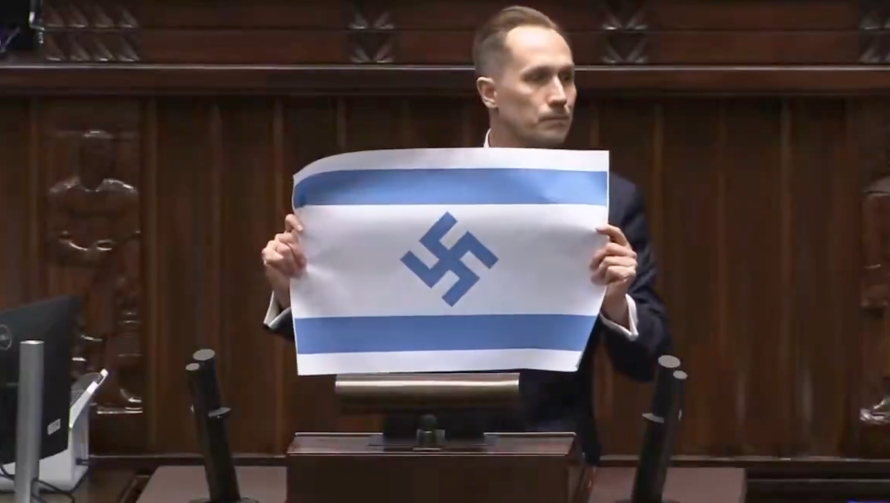 “Israel is the new Third Reich, and its flag should look exactly like this,” Konrad Berkowicz said as he unfurled the flag in parliament. (Screenshot via X)