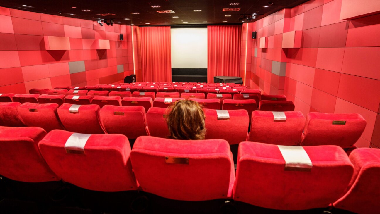 A woman sits alone in a Frankfurt, Germany, cinema in November 2021. (Frank Rumpenhorst/picture alliance via Getty Images)