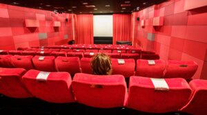A woman sits alone in a Frankfurt, Germany, cinema in November 2021. (Frank Rumpenhorst/picture alliance via Getty Images)