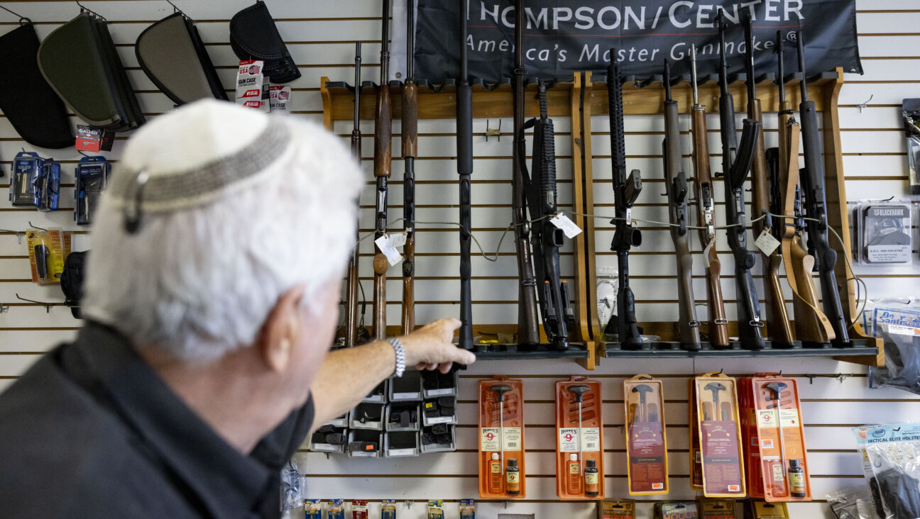 An owner points to rifles for sale at a store in Miami Beach, Florida, Oct. 23, 2023. 