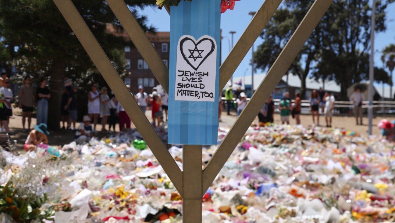 A sign reading “Jewish Lives Should Matter, Too” is seen at the floral tributes area outside Bondi Pavilion in Sydney on December 18, 2025, to honour victims of the Bondi Beach shooting. The attack at Bondi Beach on December 14 was one of the deadliest in Australian history. (Photo by DAVID GRAY / AFP via Getty Images)