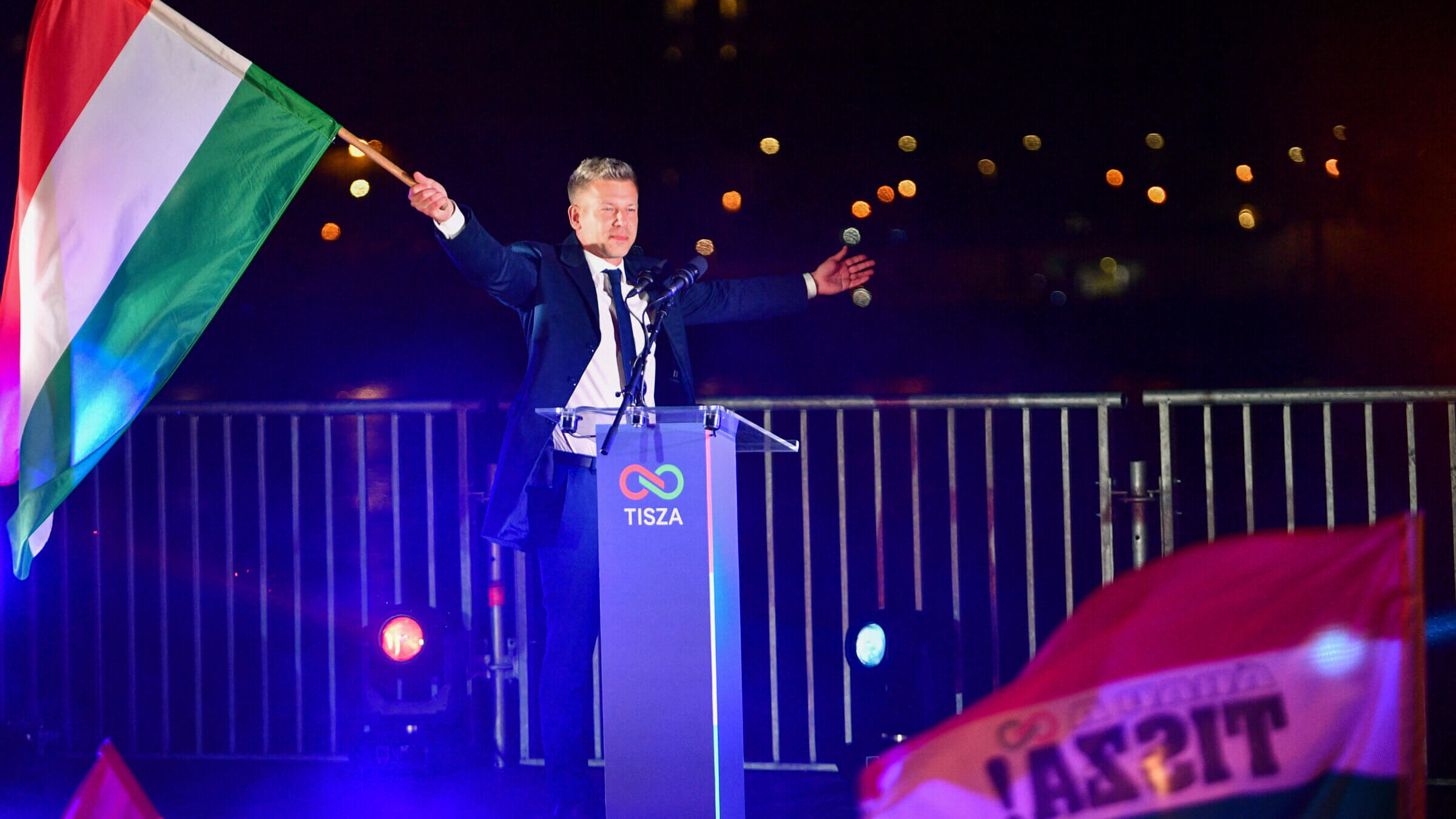 Peter Magyar, leader of the pro-European conservative TISZA party, waves the national flag during celebrations at the election night party in Budapest after the general election in Hungary, on April 12, 2026.
