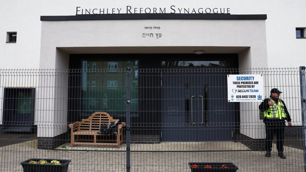A security guard stands on duty outside Finchley Reform Synagogue, in the North Finchley area of north London, on April 15, 2026, following an attack on the synagogue in the early hours of the morning.