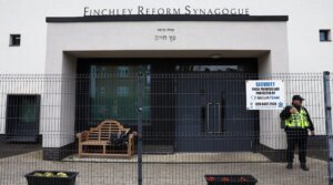 A security guard stands on duty outside Finchley Reform Synagogue, in the North Finchley area of north London, on April 15, 2026, following an attack on the synagogue in the early hours of the morning.