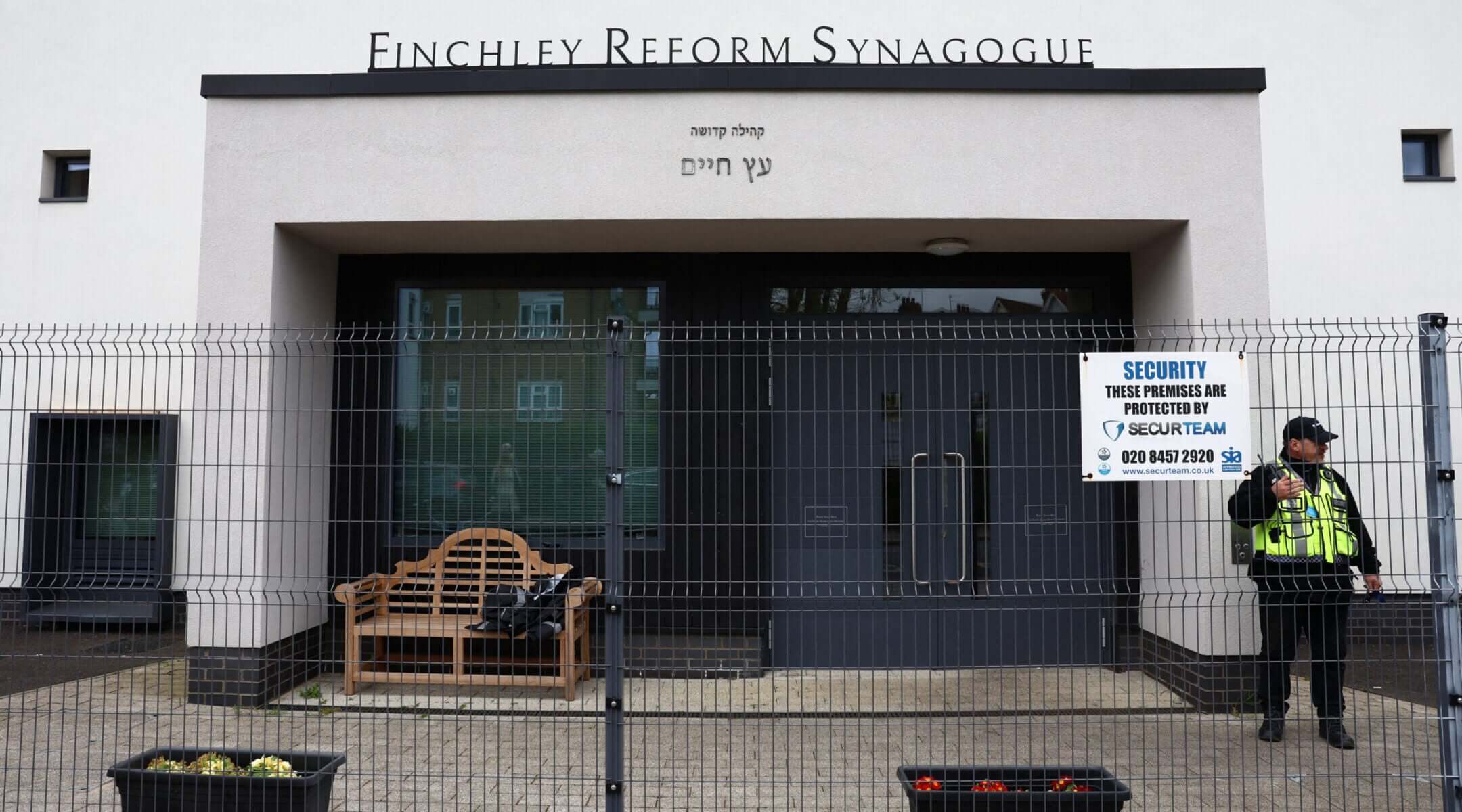 A security guard stands on duty outside Finchley Reform Synagogue, in the North Finchley area of north London, on April 15, 2026, following an attack on the synagogue in the early hours of the morning.