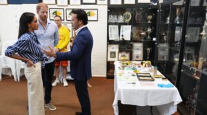Britain’s Prince Harry, and his wife Meghan Markle speak with Elon Zizer, Bondi Beach Hanukkah attack survivor, during a meeting at the Bondi Surf Bathers’ Life Saving Club in Sydney, April 17, 2026. Artifacts from the aftermath of the shooting lie on the table behind Zizer.