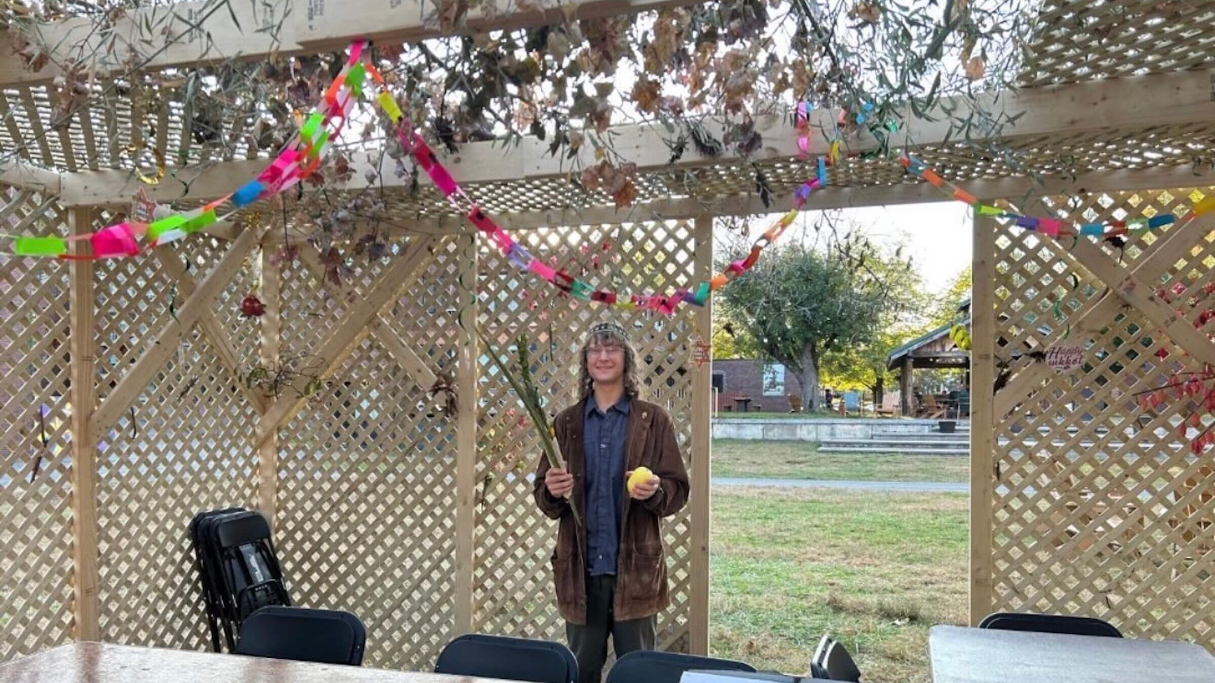 A student in a sukkah at Hampshire College. 