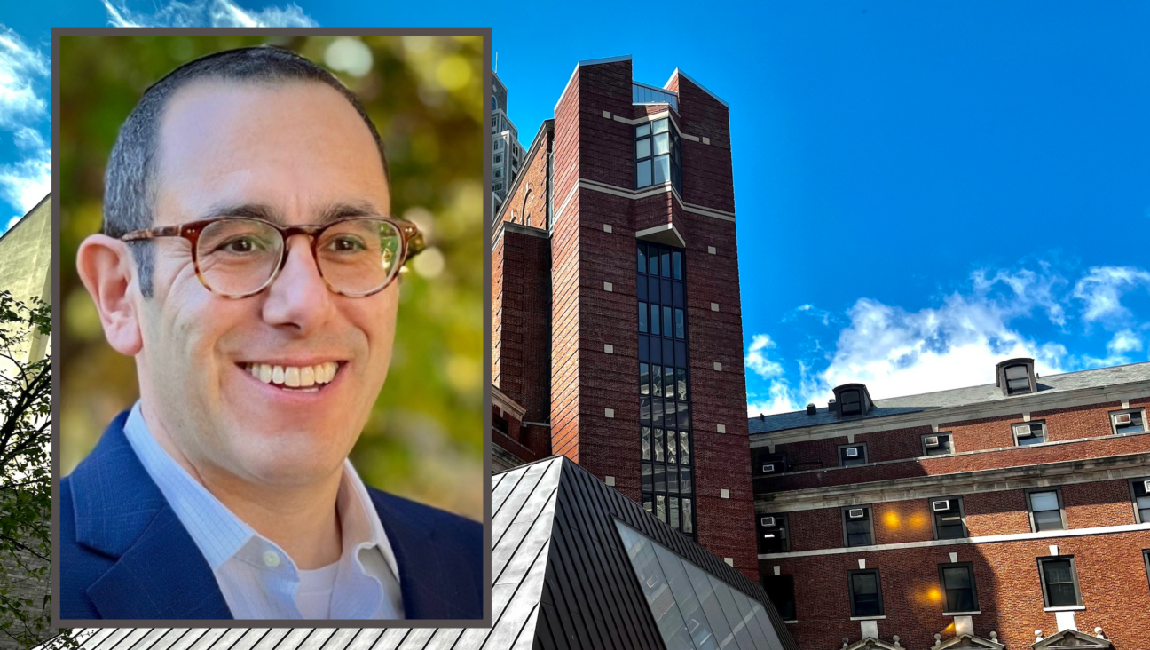 Rabbi Mikę Uram has been tapped to become the ninth chancellor of the Jewish Theological Seminary, seen at rear.