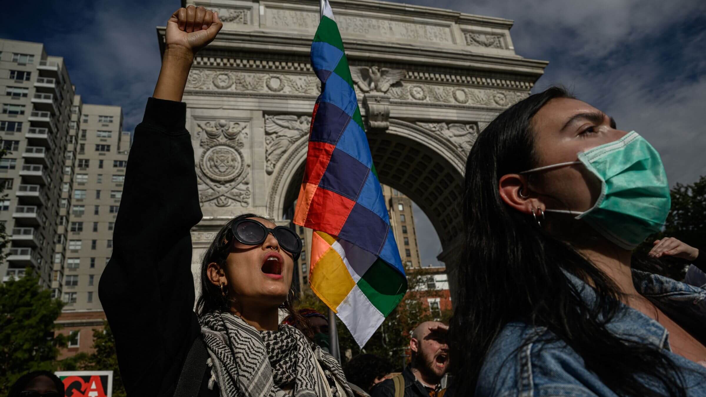 A woman raises her fist as NYU (New York University) students participate in a walkout during a national day of action called by the "Students for Justice in Palestine" at Washington Square park in New York on October 25, 2023. 