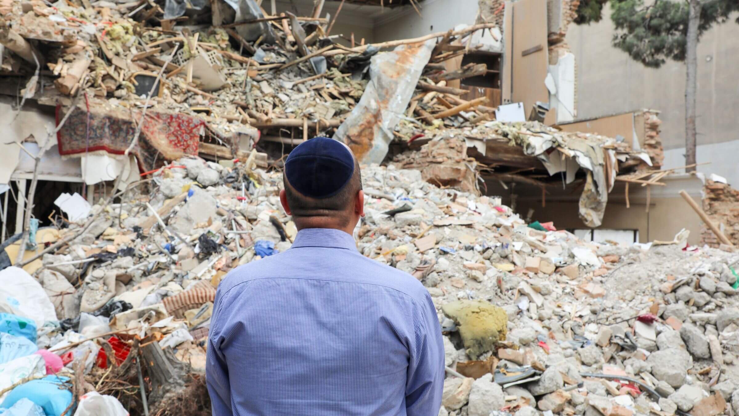 An Iranian-Jewish man looks at the ruins of a synagogue destroyed during recent U.S.-Israeli strikes on April 20 in Tehran, Iran.