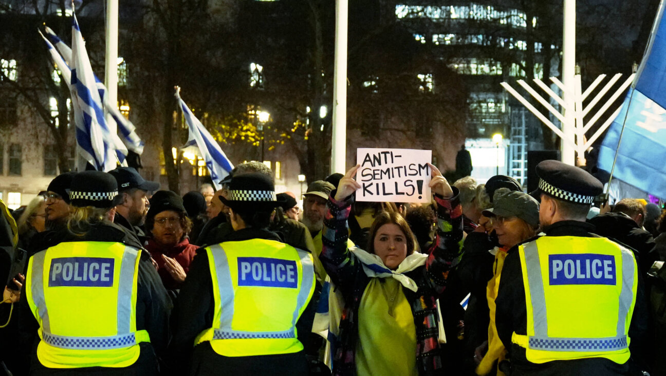 Police officers guard a Hanukkah candle-lighting organized by the Campaign Against Antisemitism and Chabad in London on Dec. 15, 2025.