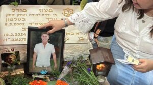 Varda Morrell lays a photo at the gravesite of her son, Israeli Staff Sgt. Maoz Morell, in 2025. (Courtesy Varda Morell)