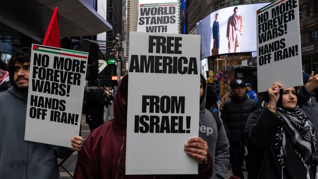 People take part in a protest and march gathering at Times Square to oppose the joint U.S.-Israel war on Iran in New York City on March 13, 2026. (Mostafa Bassim/Anadolu via Getty Images)