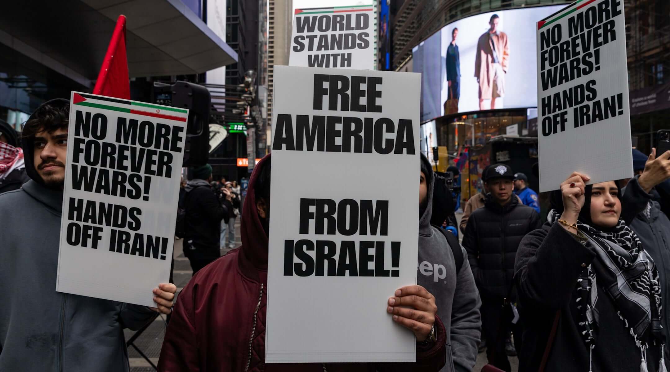 People take part in a protest and march gathering at Times Square to oppose the joint U.S.-Israel war on Iran in New York City on March 13, 2026. (Mostafa Bassim/Anadolu via Getty Images)