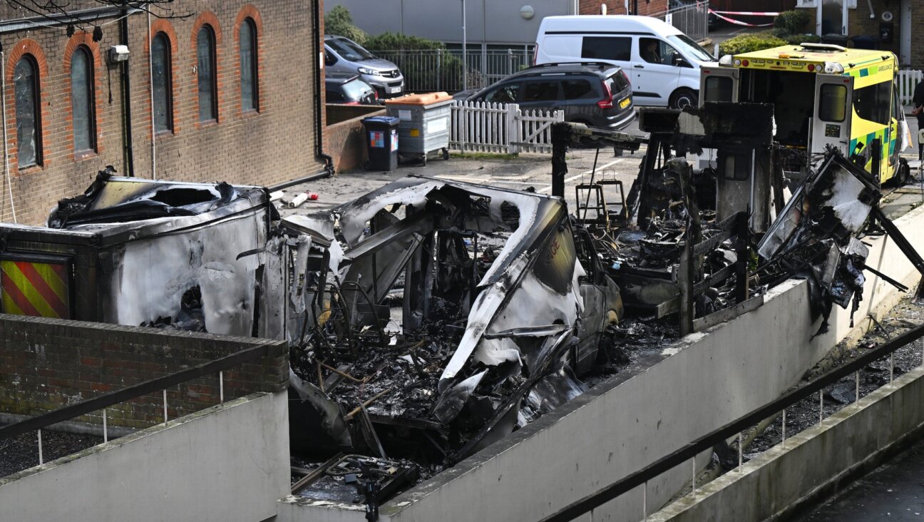 The burnt wreckage of Hatzola ambulances as fire services continue to monitor the scene after they were set on fire overnight next to Machzike Hadath Synagogue, on March 23, 2026 in the Golders Green area of London, England.