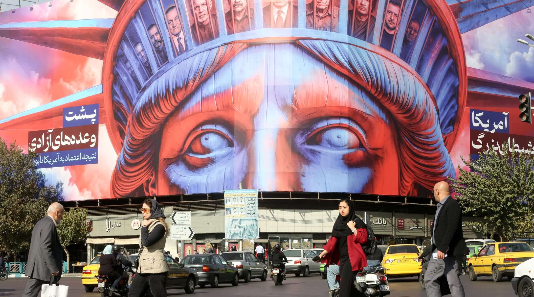 A poster is hung in Tehran’s Revolution Square featuring an image of the Statue of Liberty, and photographs of several heads of state to mark the 46th anniversary of the U.S. Embassy takeover and hostage crisis in Tehran, Iran on November 5, 2025. 