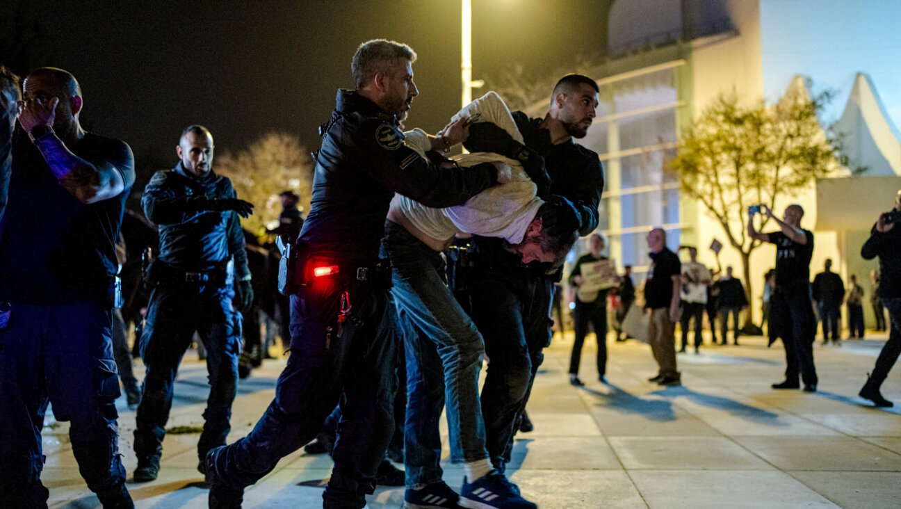 Israeli police arrest an anti-war protester amid a gathering in Habima Square in Tel Aviv on April 4.
