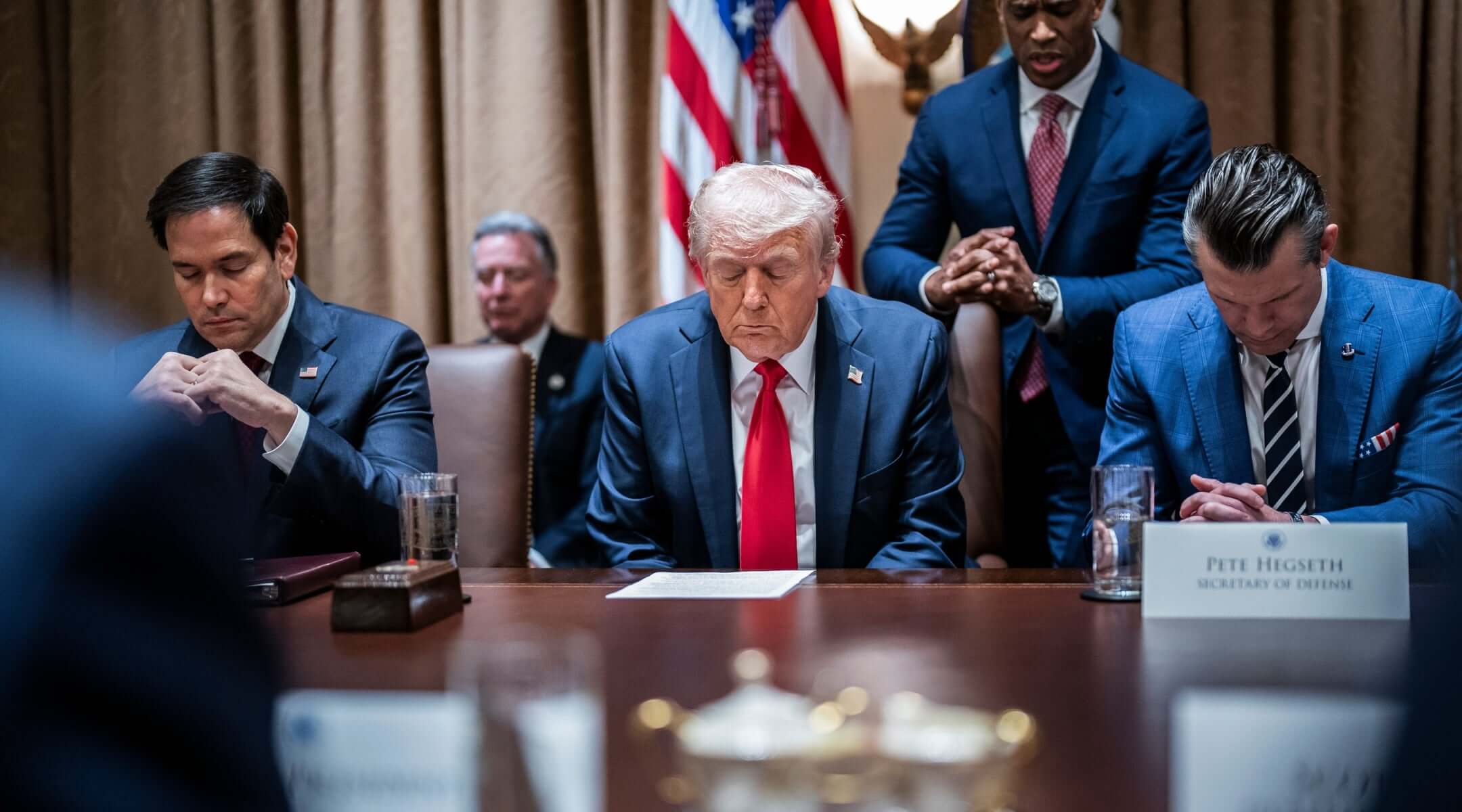 President Donald Trump prays at the first cabinet meeting of his second term at the White House in February, 2025. (Jabin Botsford/The Washington Post via Getty Images)