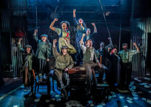 The cast of <i>Cable Street</i> pump their fists following a short-lived victory over fascism.
