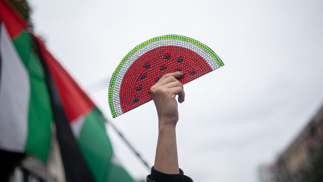 A protester holds a watermelon sign at a rally supporting Palestinians in Gaza, in Berlin, Oct. 6, 2024. (Babak Bordbar / Middle East Images / Middle East Images / AFP via Getty Images)
