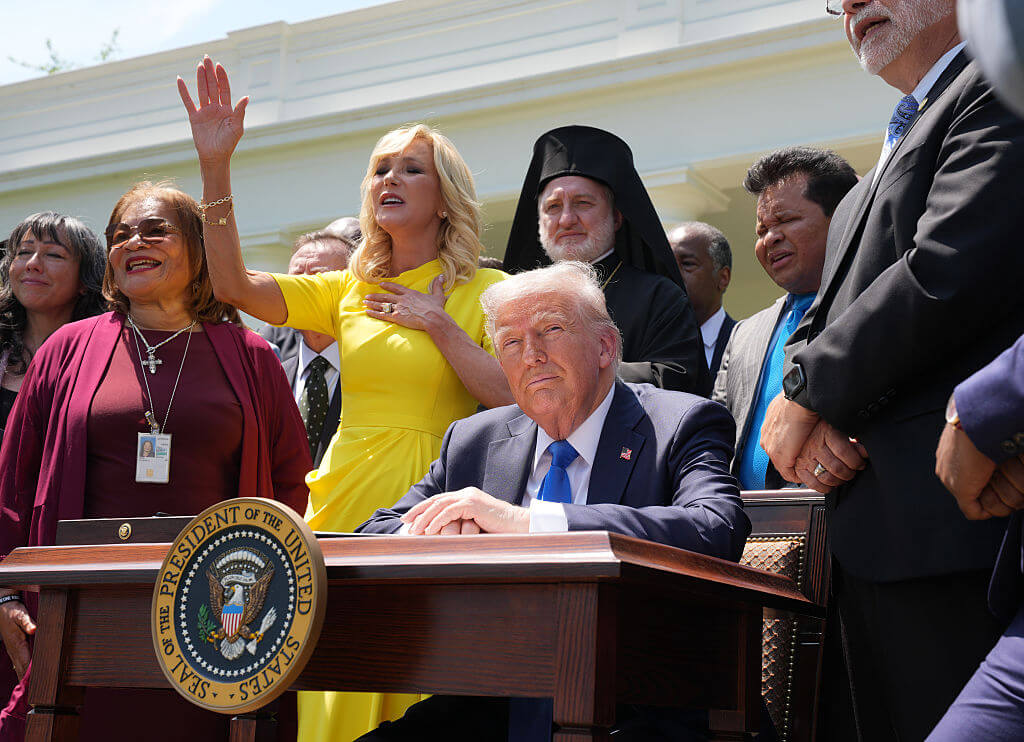 Paula White, head of the White House Faith Office, leads a prayer next to President Donald Trump and other religious leaders during a National Day of Prayer event at the White House in May 2025.