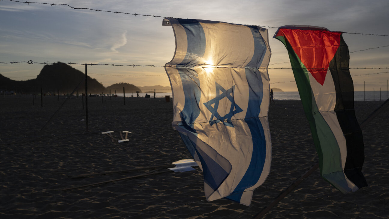 An Israeli and a Palestinian flag hang side by side.