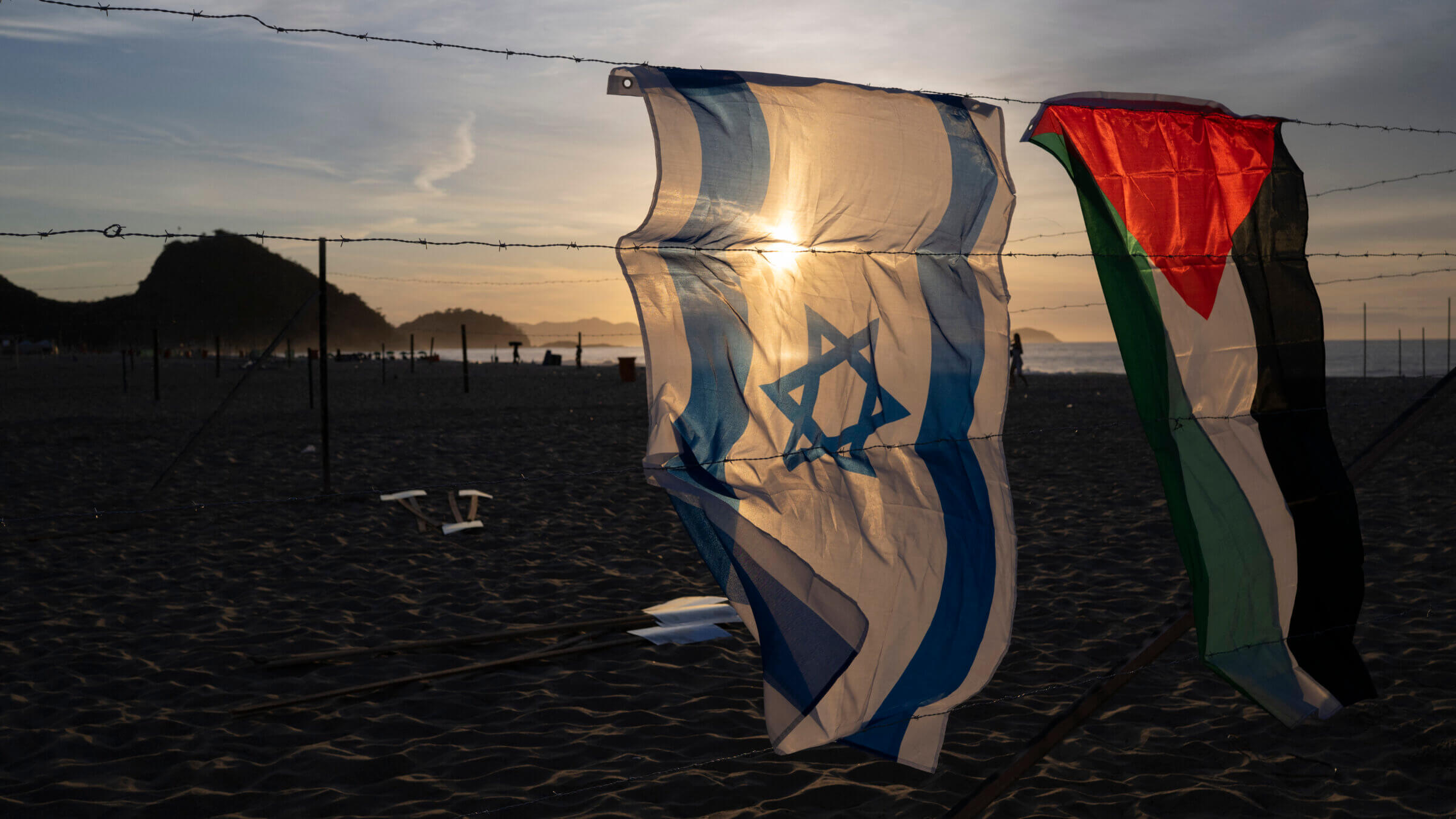 An Israeli and a Palestinian flag hang side by side.