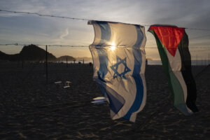 An Israeli and a Palestinian flag hang side by side.