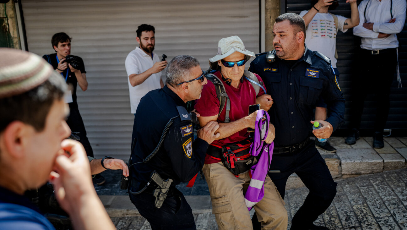 Israeli border police officers forcibly remove a left-wing activist from Jerusalem's Old City during Jerusalem Day celebrations on May 14, 2026 in the Old City of Jerusalem.
