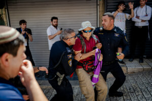 Israeli border police officers forcibly remove a left-wing activist from Jerusalem's Old City during Jerusalem Day celebrations on May 14, 2026 in the Old City of Jerusalem.
