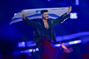 Noam Bettan representing Israel walks into the grand final carrying the Israeli flag during the Grand Final of the 70th Eurovision Song Contest at Wiener Stadthalle on May 16, 2026. 