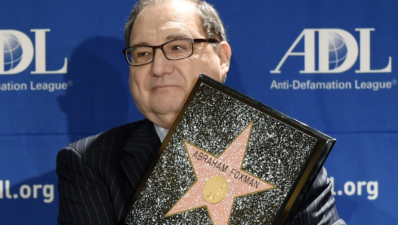 Abraham Foxman holds a replica of the Hollywood Walk of Fame Star as he is honored by the Anti-Defamation League 2014 Annual Meeting at The Beverly Hilton in Beverly Hills, California.
