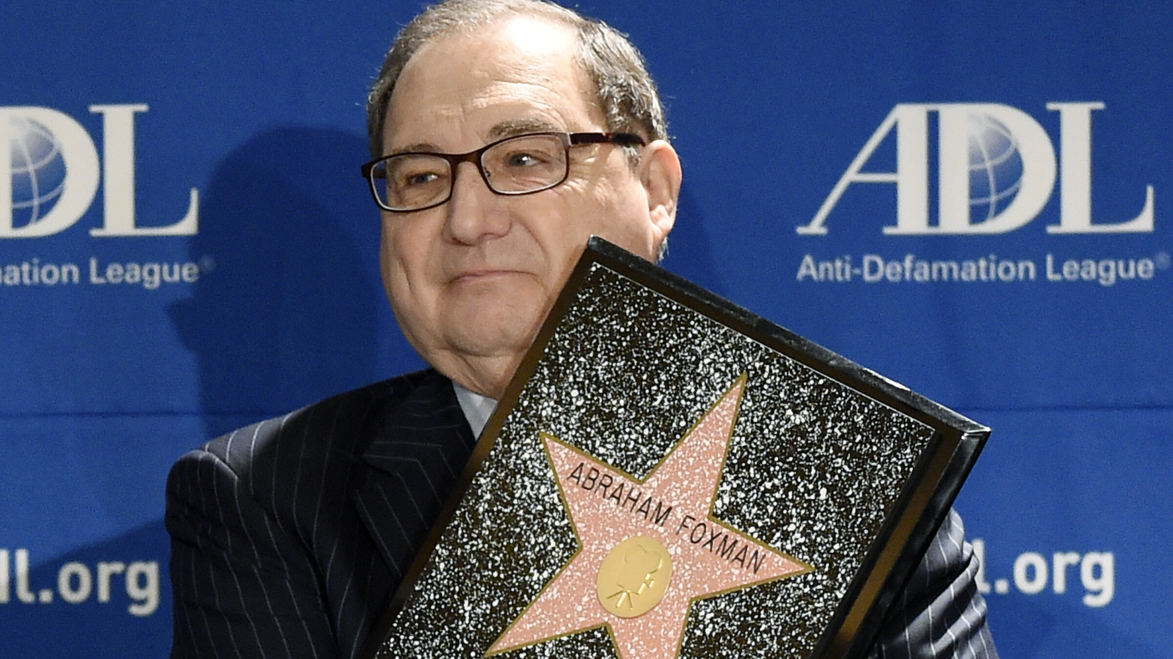 Abraham Foxman holds a replica of the Hollywood Walk of Fame Star as he is honored by the Anti-Defamation League 2014 Annual Meeting at The Beverly Hilton in Beverly Hills, California.