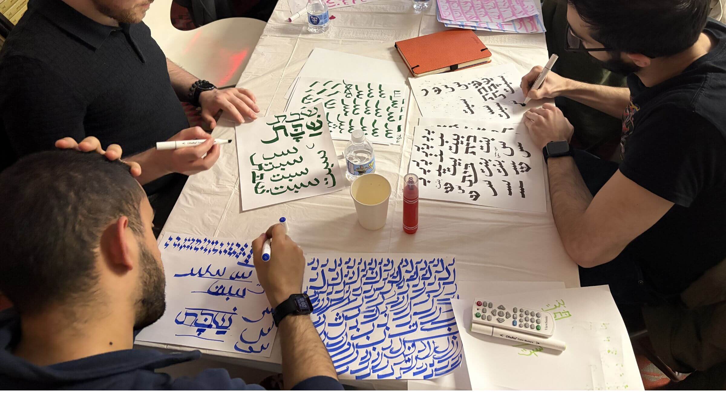 Sacred Script fellows practicing their Hebrew and Arabic calligraphy 