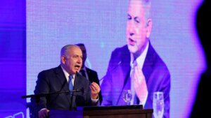 Israeli Prime Minister Benjamin Netanyahu delivers a speech before lighting a stylised-menorah during the start of Hanukkah, the Jewish festival of lights, in Ramat Gan in the suburbs of the Mediterranean coastal city of Tel Aviv on December 2, 2018. 