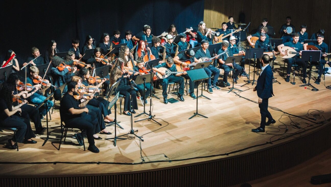Tom Cohen conducts the youth program of The Jerusalem Orchestra East & West in Tel Aviv, May 2026. (Yaakov Buta)