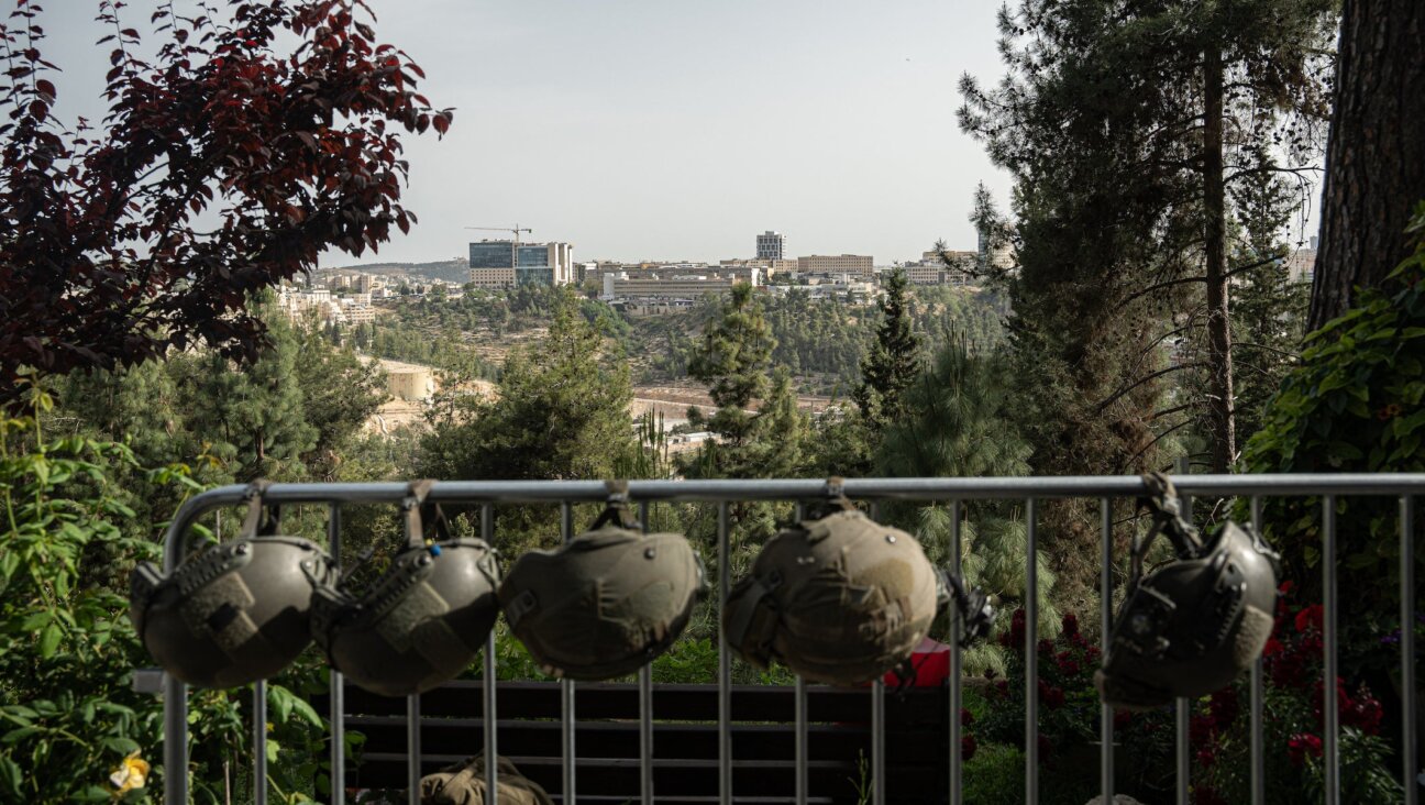 IDF soldiers’ helmets are hung from a rail, with Jerusalem in the background, on Israel’s Memorial Day on April 30, 2025 in Jerusalem, Israel. (Ori Aviram / Middle East Images / Middle East Images via AFP)