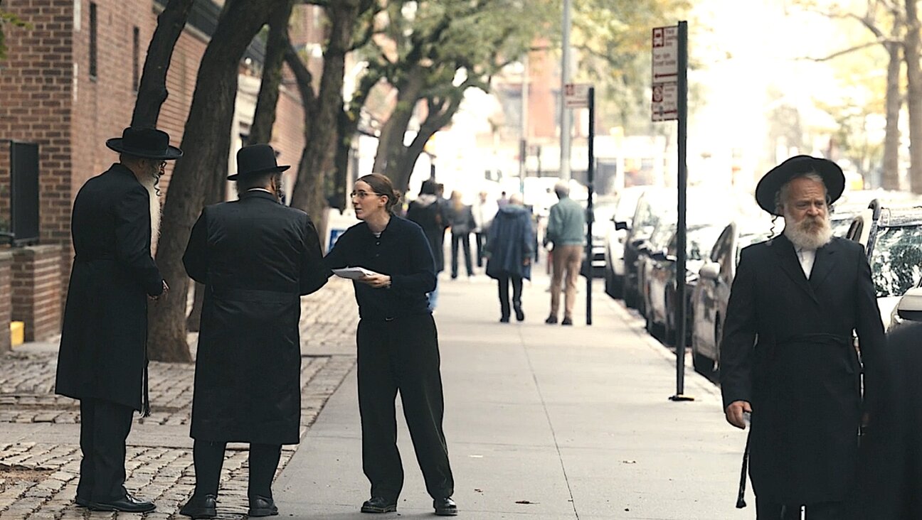 Robbie Hoffman, who plays Randi, handing out fliers in a Hasidic neighborhood.