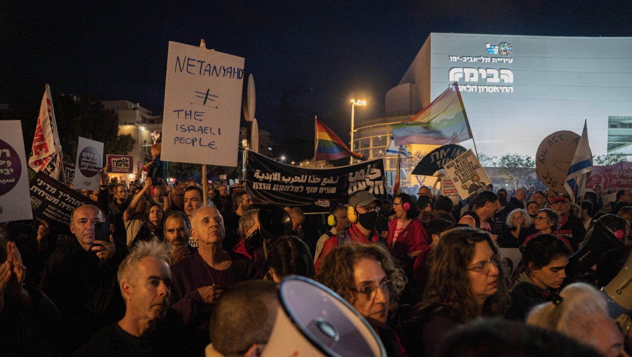 Israeli left-wing activists hold placards during an anti-war and anti-government demonstration in Tel Aviv, Israel, on April 11.