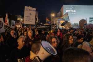 Israeli left-wing activists hold placards during an anti-war and anti-government demonstration in Tel Aviv, Israel, on April 11.