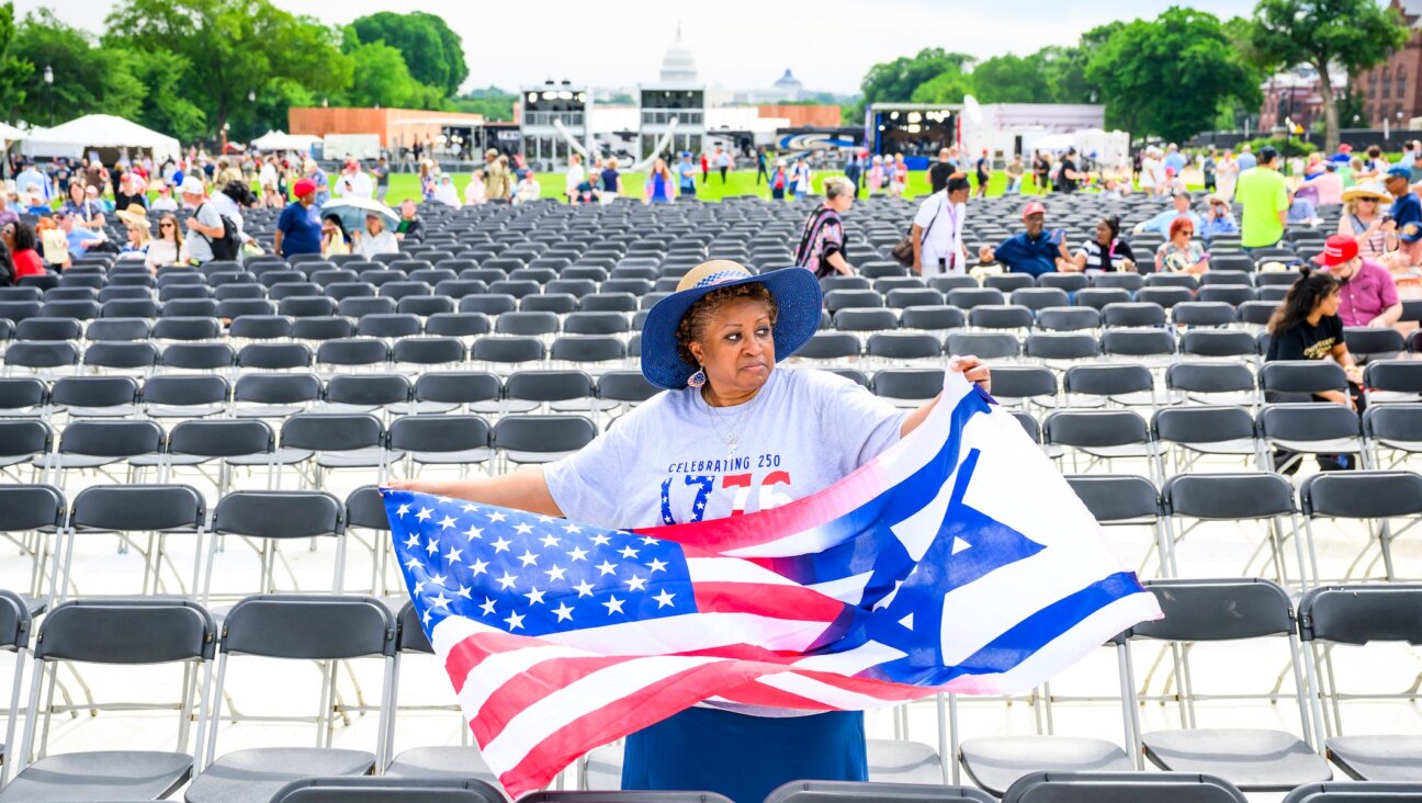 A woman holds a combination American-Israeli flags during Rededicate 250: A National Jubilee Of Prayer, Praise & Thanksgiving on the National Mall on May 17, 2026 in Washington, DC.