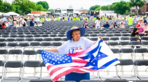 A woman holds a combination American-Israeli flags during Rededicate 250: A National Jubilee Of Prayer, Praise & Thanksgiving on the National Mall on May 17, 2026 in Washington, DC.