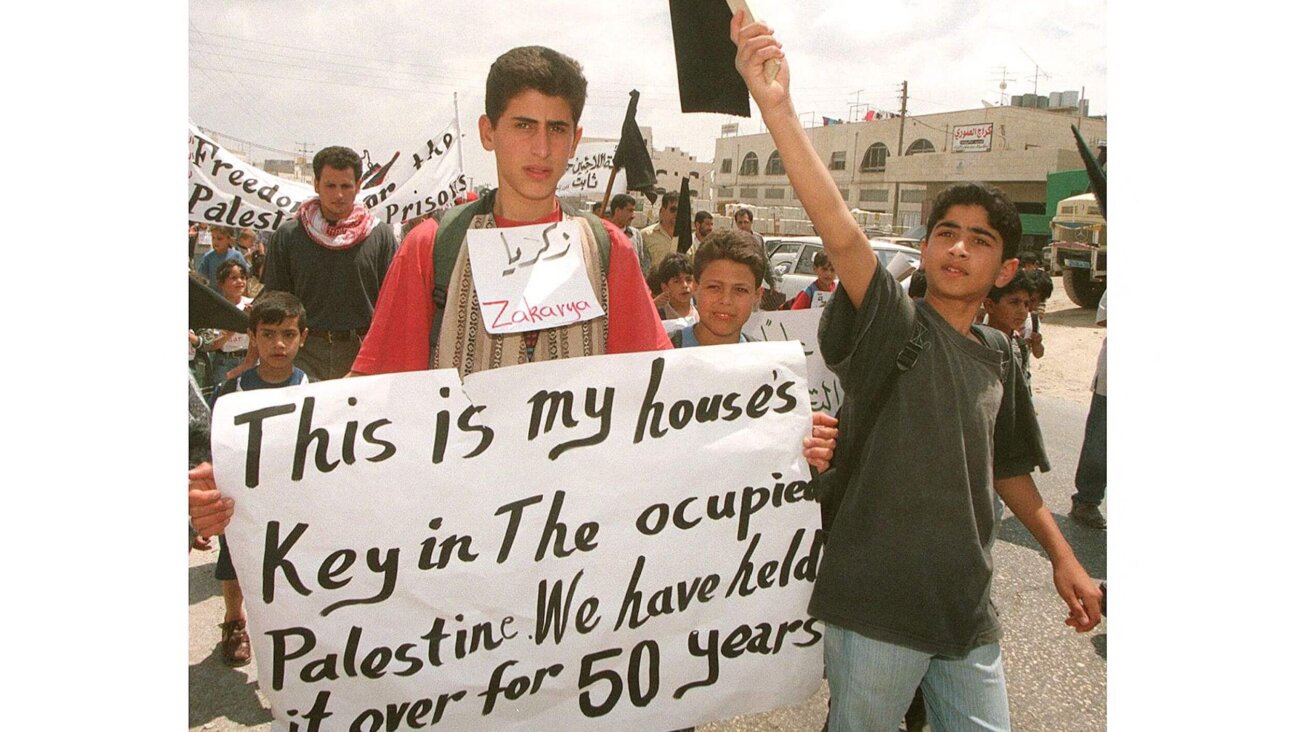 Young Palestinian refugees demonstrate at the Daheisheh refugee camp outside the West Bank town of Bethlehem on May 13, 1998. Some 500 schoolchildren joined a "march of the keys" to mark the 50th anniversary of the Nakba — "catastrophe" in Arabic — the exodus of 700,000 Palestinian refugees from their land upon Israel's creation.