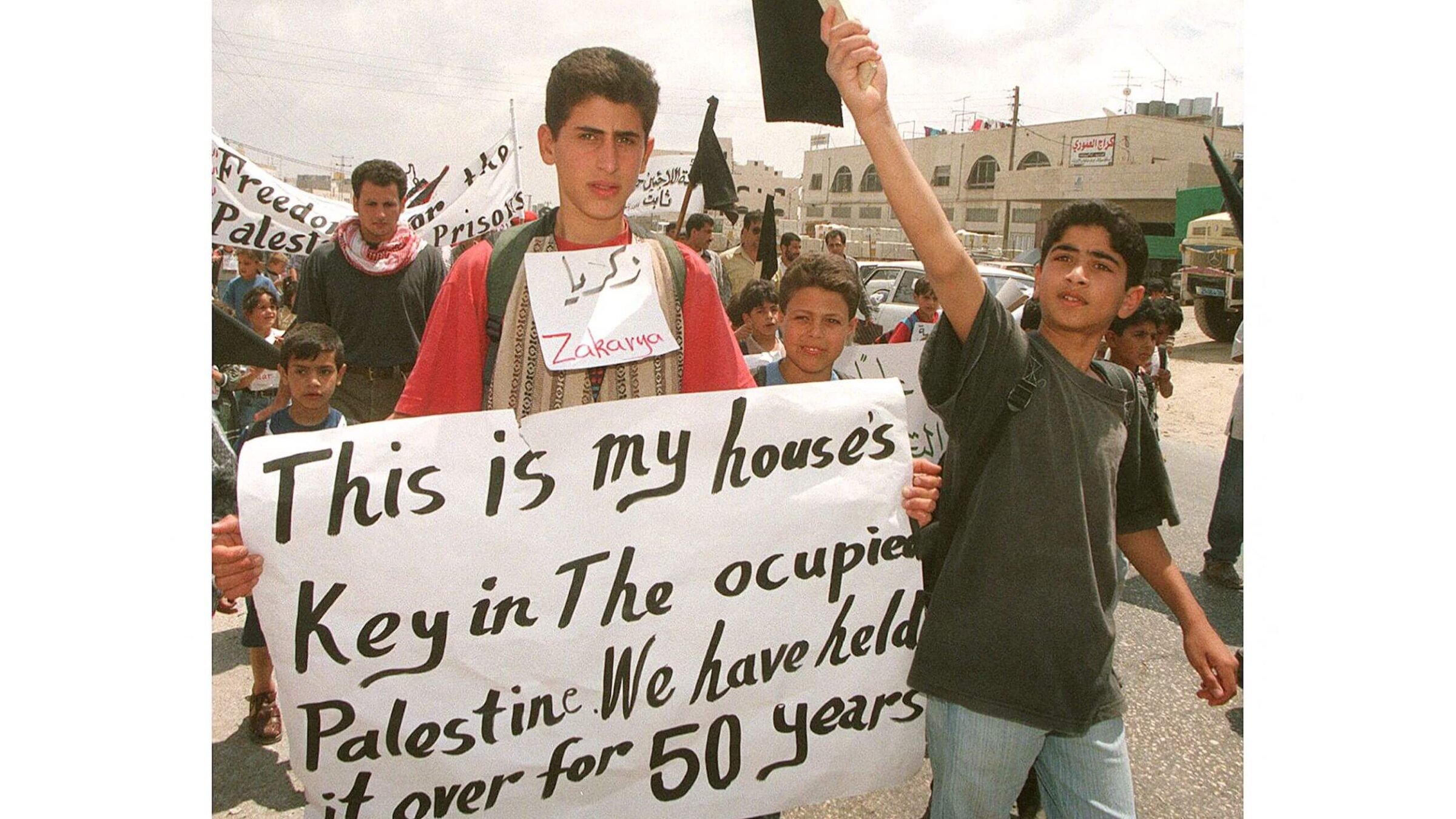 Young Palestinian refugees demonstrate at the Daheisheh refugee camp outside the West Bank town of Bethlehem on May 13, 1998. Some 500 schoolchildren joined a "march of the keys" to mark the 50th anniversary of the Nakba — "catastrophe" in Arabic — the exodus of 700,000 Palestinian refugees from their land upon Israel's creation.