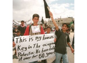 Young Palestinian refugees demonstrate at the Daheisheh refugee camp outside the West Bank town of Bethlehem on May 13, 1998. Some 500 schoolchildren joined a "march of the keys" to mark the 50th anniversary of the Nakba — "catastrophe" in Arabic — the exodus of 700,000 Palestinian refugees from their land upon Israel's creation.