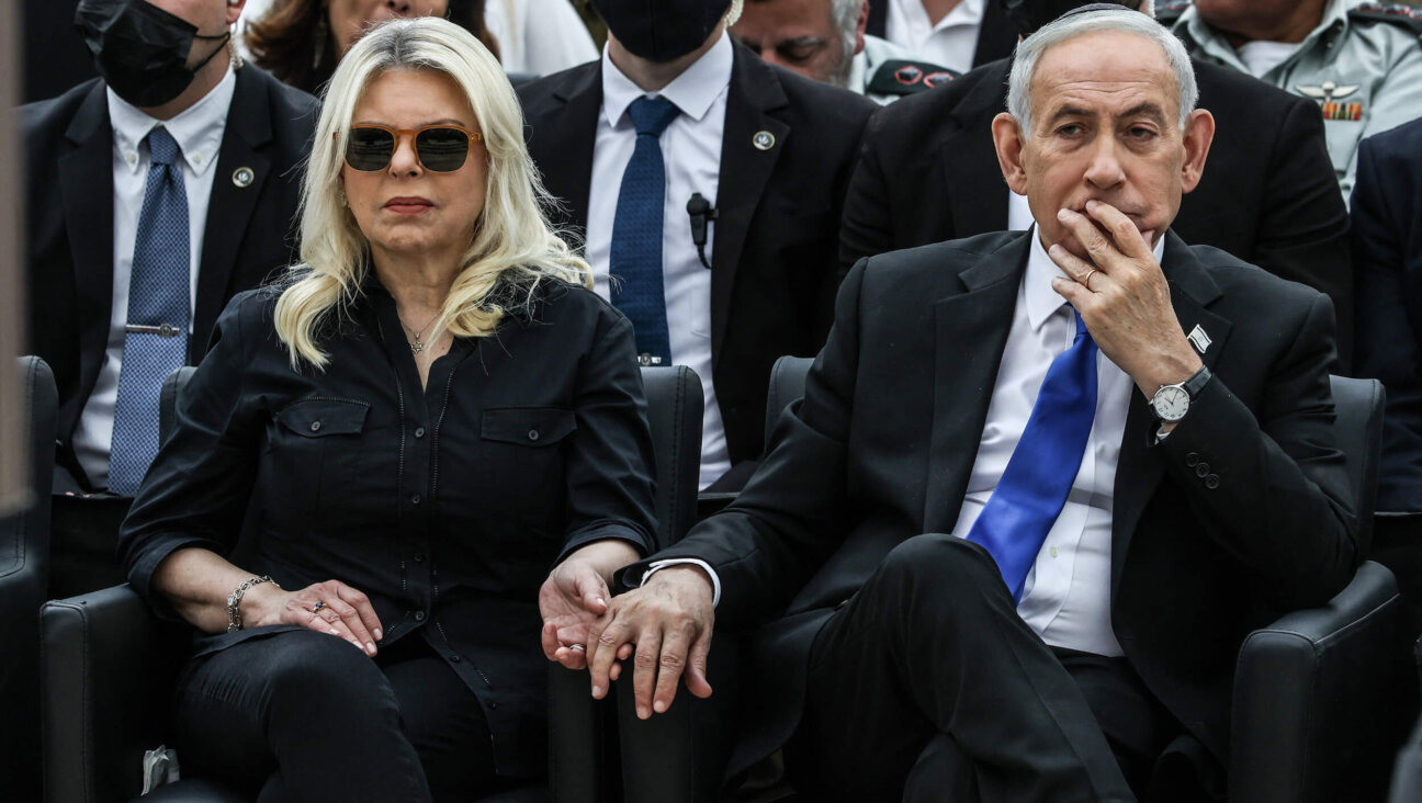 Israeli Prime Minister Benjamin Netanyahu holds the hand of his wife Sara as they attend a ceremony commemorating Yom HaZikaron at the Military Cemetery on Mount Herzl in Jerusalem on April 21.