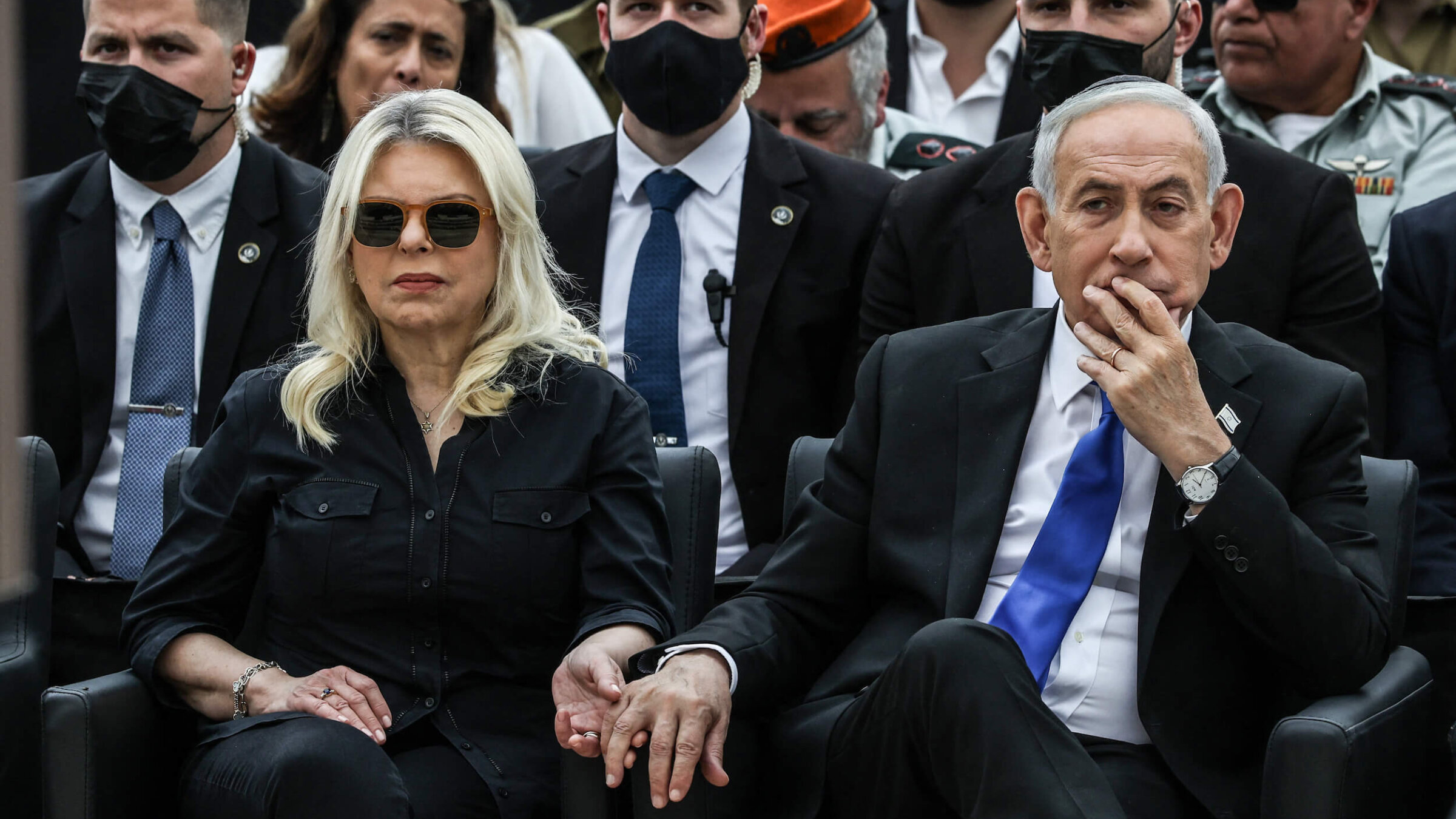 Israeli Prime Minister Benjamin Netanyahu holds the hand of his wife Sara as they attend a ceremony commemorating Yom HaZikaron at the Military Cemetery on Mount Herzl in Jerusalem on April 21.