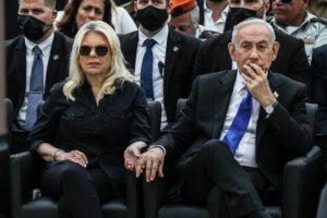 Israeli Prime Minister Benjamin Netanyahu holds the hand of his wife Sara as they attend a ceremony commemorating Yom HaZikaron at the Military Cemetery on Mount Herzl in Jerusalem on April 21.
