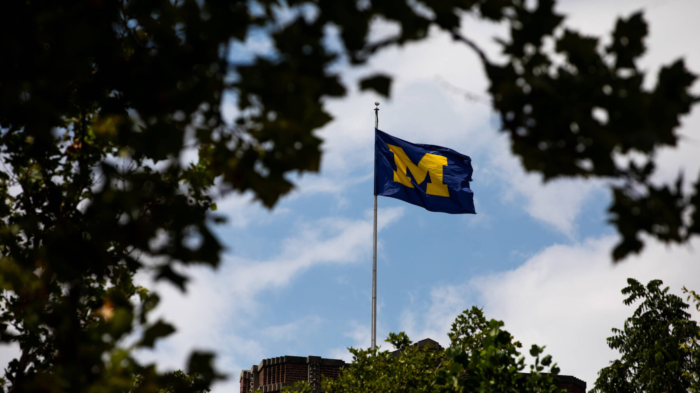 A University of Michigan flag on the Michigan Union building on campus in Ann Arbor, Michigan.