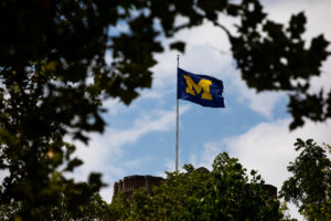 A University of Michigan flag on the Michigan Union building on campus in Ann Arbor, Michigan.